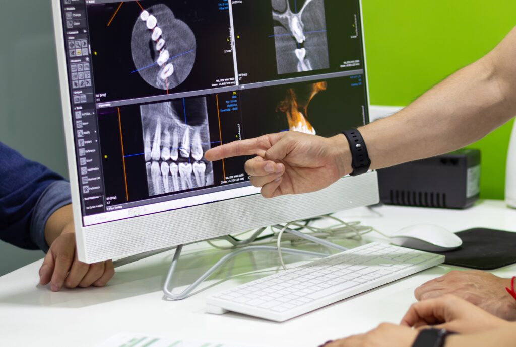Dental professional discussing mouth x-ray with patient